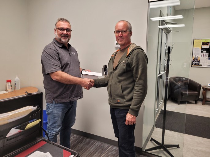 President Darryl Dziadyk presents a Retiree of Local 7458 with an hours pay from each of the members of the local and a coffee mug and coop gift card from the membership.